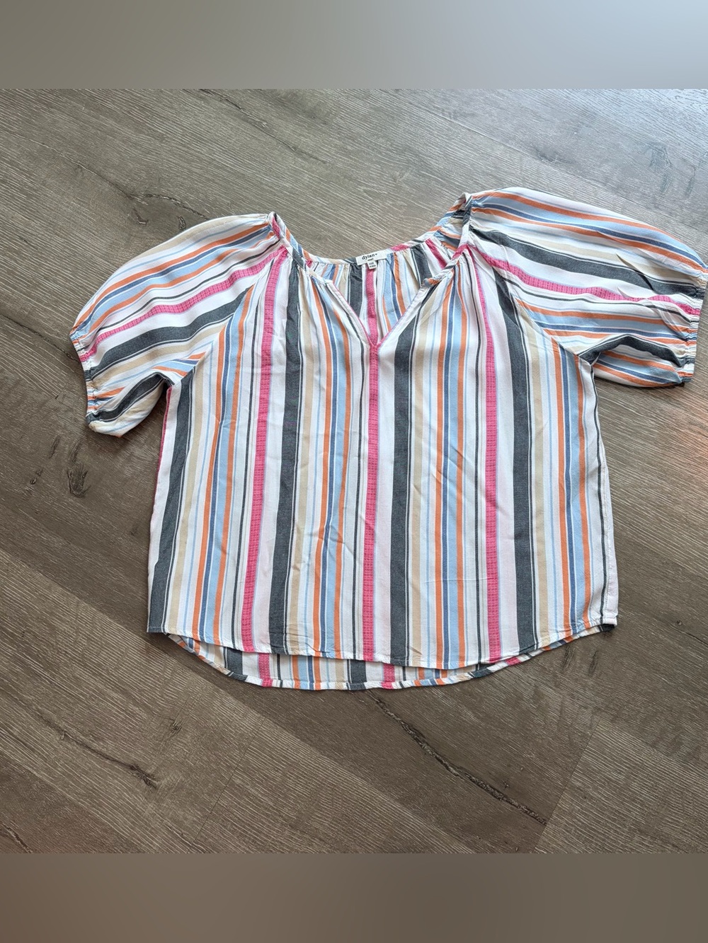 Dylan brand peasant blouse features a V-neckline and colorful vertical stripes